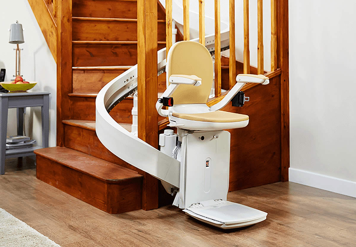 Acorn Curved stairlift navigating complex staircase with 180-degree turn, demonstrating smooth operation on non-linear stairs