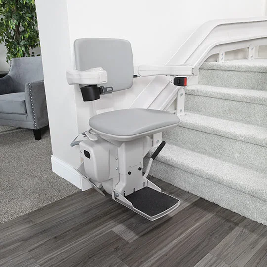 Bruno Elite Curved stairlift custom-fitted to curved residential staircase with landing transitions, showing smooth corner navigation