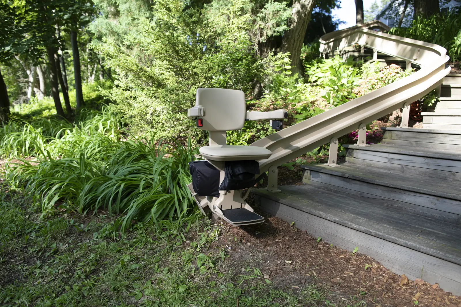 Custom outdoor stairlift solution showing bespoke installation on unique residential staircase configuration with specialized outdoor design